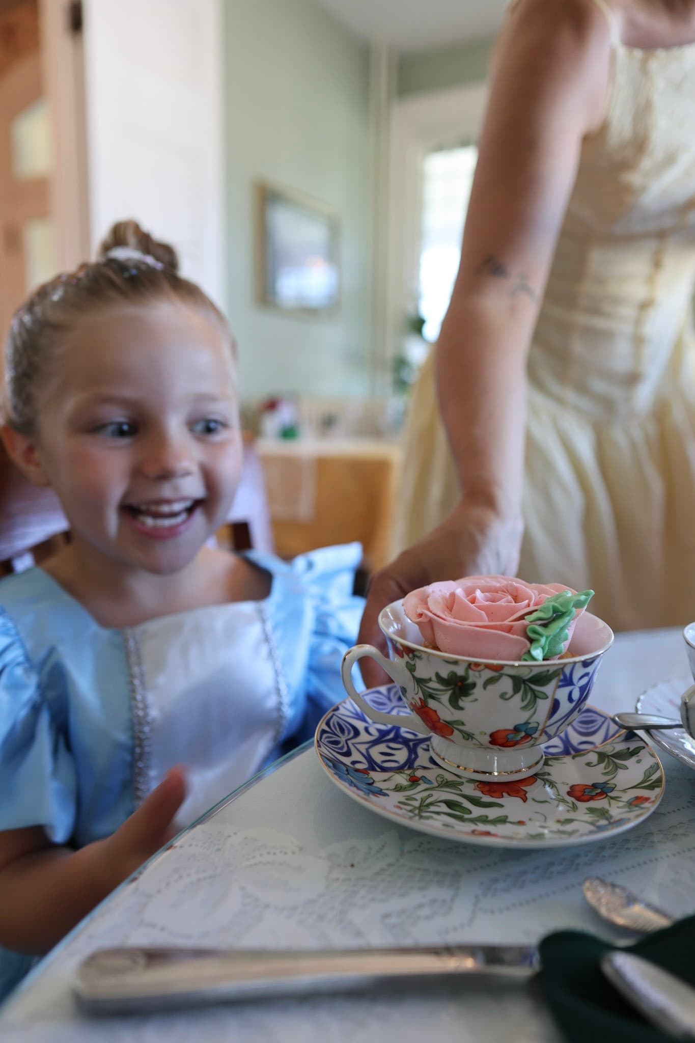 Rose cupcake in a floral teacup for a birthday tea party at The Tea Trolley